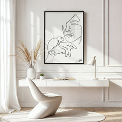 Abstract floral line art of a woman’s face with blooming flowers on canvas in modern room setting

