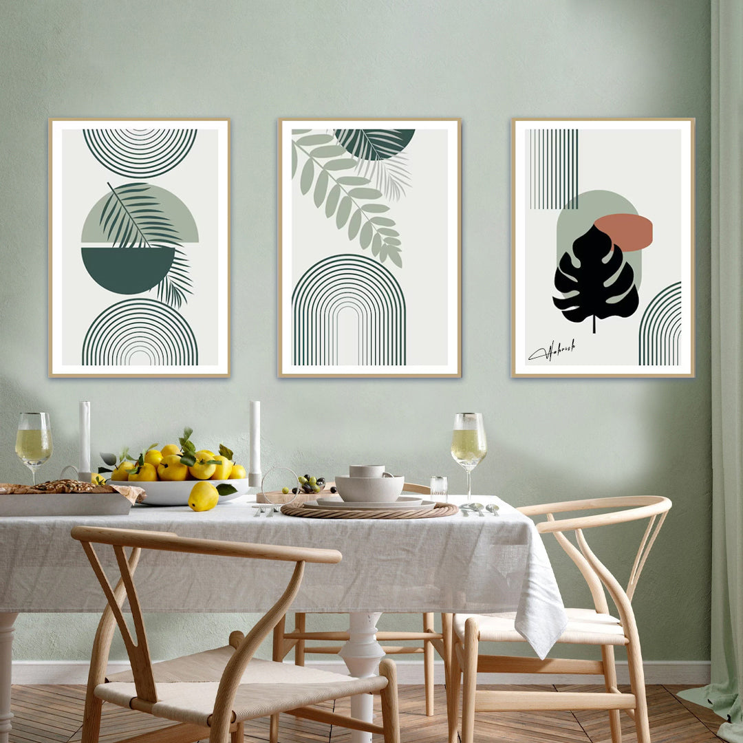 Set of 3 minimalist geometric botanical wall art prints in green and neutral tones, displayed in a modern dining room setting.
